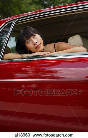 Woman in moving car, leaning on door frame, looking away View Large Photo Image Stock Image - Woman in moving car, leaning on door frame, looking away. Fotosearch