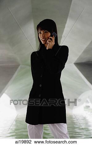 Woman in tunnel using mobile phone View Large Photo Image Stock Image - Woman in tunnel using mobile phone. Fotosearch