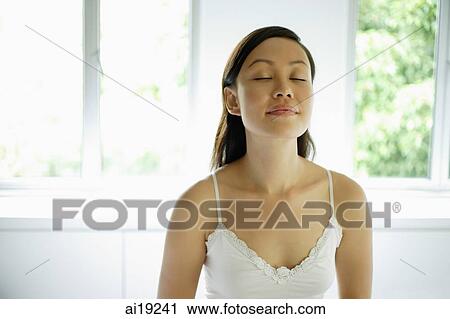 Woman in white tank top with eyes closed View Large Photo Image Stock Image - Woman in white tank top with eyes closed. Fotosearch