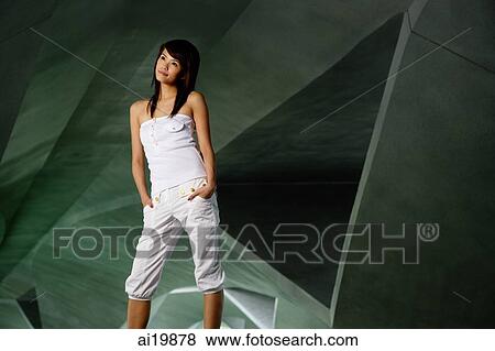 Woman in white tube top and white pants, hands in pockets, looking away View Large Photo Image Stock Photo - Woman in white tube top and white pants, hands in pockets, looking away. Fotosearch
