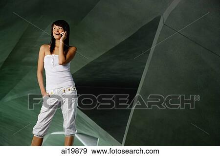 Woman in white tube top and white pants, using mobile phone View Large Photo Image Stock Photo - Woman in white tube top and white pants, using mobile phone. Fotosearch