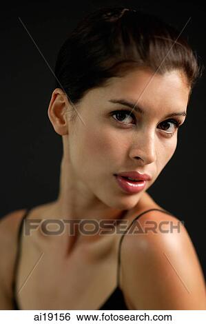 Woman looking at camera, head shot View Large Photo Image Stock Photograph - Woman looking at camera, head shot. Fotosearch
