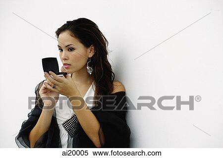 Woman looking at compact View Large Photo Image Stock Photography - Woman looking at compact. Fotosearch