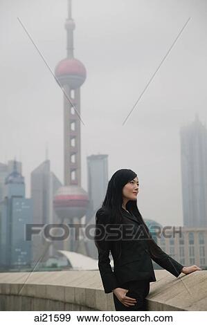 Woman looking away, Oriental Pearl TV Tower in the background View Large Photo Image Stock Photo - Woman looking away, Oriental Pearl TV Tower in the background. Fotosearch