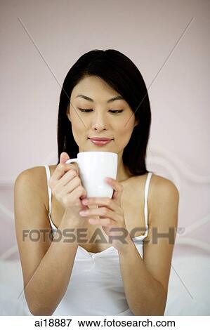 Stock Photo - Woman looking into cup. Fotosearch