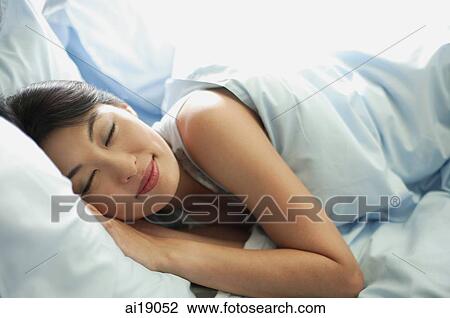Woman lying in bed, sleeping View Large Photo Image Stock Image - Woman lying in bed, sleeping. Fotosearch