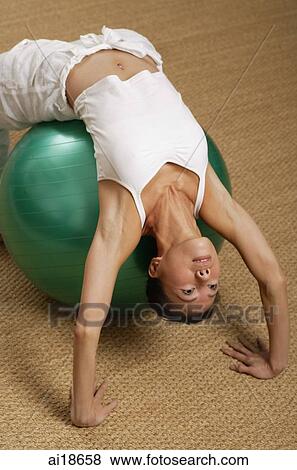 Woman lying on fitness ball View Large Photo Image Stock Photo - Woman lying on fitness ball. Fotosearch