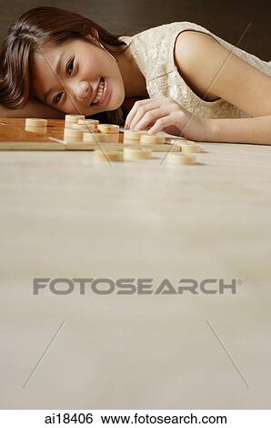 Woman lying on floor, Chinese chess pieces on floor next to her View Large Photo Image Stock Photograph - Woman lying on floor, Chinese chess pieces on floor next to her. Fotosearch