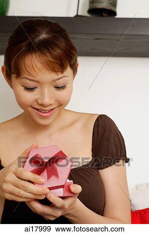 Woman opening gift box View Large Photo Image Stock Photo - Woman opening gift box. Fotosearch