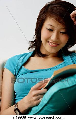 Woman reading book, smiling View Large Photo Image Stock Photo - Woman reading book, smiling. Fotosearch