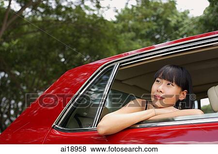 Woman sitting in moving car, looking out the window View Large Photo Image Stock Photo - Woman sitting in moving car, looking out the window. Fotosearch