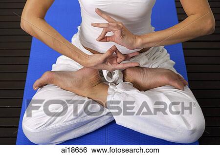 Woman sitting in yoga position, low section View Large Photo Image Stock Photograph - Woman sitting in yoga position, low section. Fotosearch