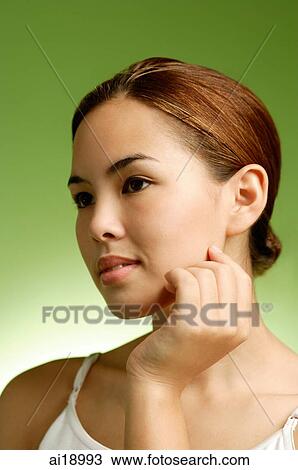 Woman touching face, headshot View Large Photo Image Stock Image - Woman touching face, headshot. Fotosearch