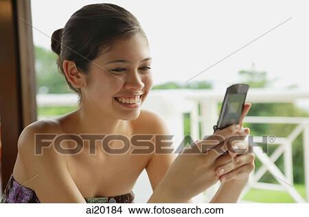 Woman using mobile phone, text messaging View Large Photo Image Picture - Woman using mobile phone, text messaging. Fotosearch