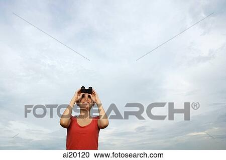 Woman with binoculars looking at sky View Large Photo Image Stock Image - Woman with binoculars looking at sky. Fotosearch