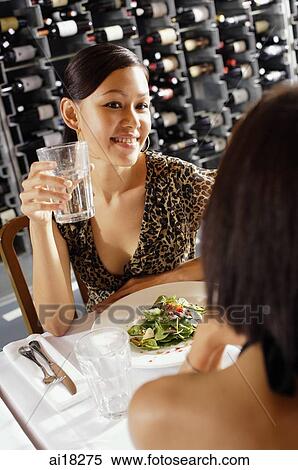 Download Women dining in restaurant, over the shoulder view Stock ...