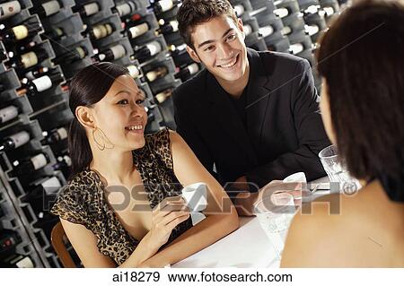 Young adults having coffee in restaurant View Large Photo Image Stock Photo - Young adults having coffee in restaurant. Fotosearch