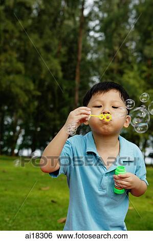 Young boy blowing bubbles View Large Photo Image Stock Photograph - Young boy blowing bubbles. Fotosearch