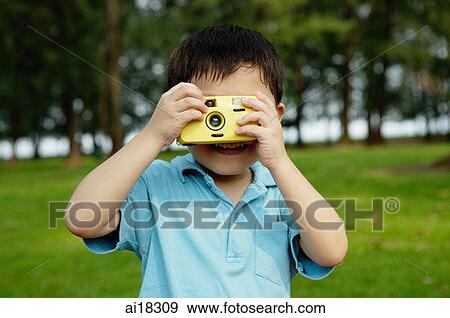 Young boy taking pictures with yellow camera View Large Photo Image Stock Photo - Young boy taking pictures with yellow camera. Fotosearch
