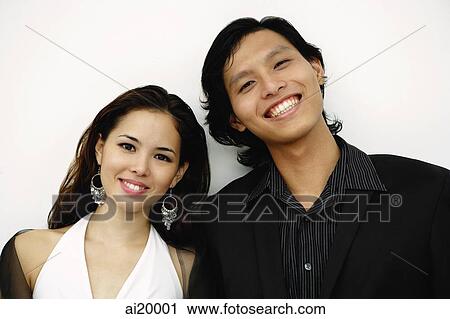 Young couple smiling at camera View Large Photo Image Stock Image - Young couple smiling at camera. Fotosearch