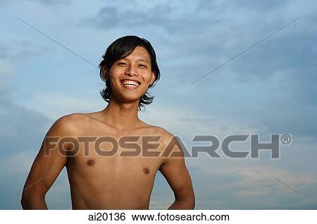 Young man smiling at camera View Large Photo Image Stock Photograph - Young man smiling at camera. Fotosearch