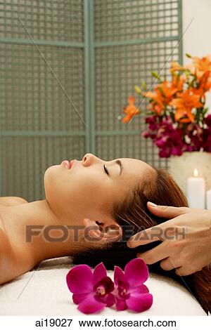 Young woman having a head massage View Large Photo Image Stock Photo - Young woman having a head massage. Fotosearch