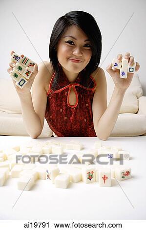 Young woman holding mahjong tiles View Large Photo Image Stock Image - Young woman holding mahjong tiles. Fotosearch