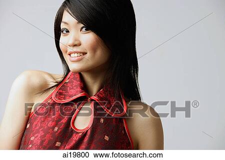 Young woman in red top, smiling at camera View Large Photo Image Stock Image - Young woman in red top, smiling at camera. Fotosearch