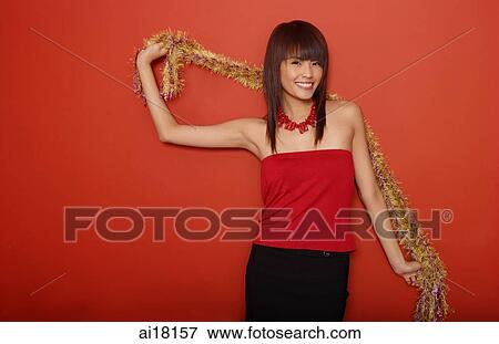 Stock Photo - Young woman in red tube top with feather boa. Fotosearch