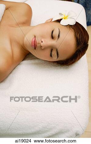 Young woman massage table, eyes closed, head shot View Large Photo Image Picture - Young woman massage table, eyes closed, head shot. Fotosearch