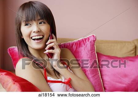 Young woman using mobile phone View Large Photo Image Picture - Young woman using mobile phone. Fotosearch