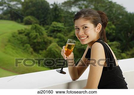 Young woman with champagne glass View Large Photo Image Stock Image - Young woman with champagne glass. Fotosearch
