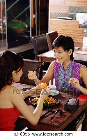 Young women having a meal in restaurant View Large Photo Image Stock Photography - Young women having a meal in restaurant. Fotosearch