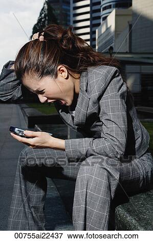 A businesswoman looks stressed as she sits down View Large Photo Image Stock Photo - A businesswoman looks stressed as she sits down. Fotosearch
