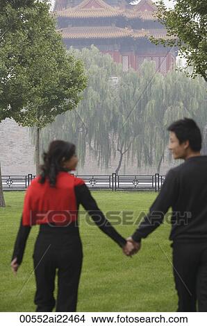 A couple hold hands in front of The Forbidden City, Beijing View Large Photo Image Picture - A couple hold hands in front of The Forbidden City, Beijing. Fotosearch