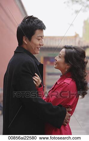 Stock Image - A couple hug and smile at each other. Fotosearch