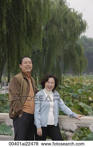 Stock Photo - A couple look at the camera and laugh. Fotosearch