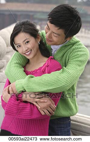 A couple smile as they have their arms around each other View Large Photo Image Stock Image - A couple smile as they have their arms around each other. Fotosearch