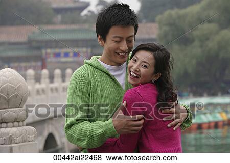 A couple smile as they hug View Large Photo Image Stock Photo - A couple smile as they hug. Fotosearch