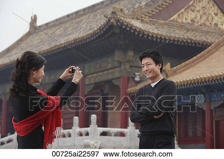A couple take photos of each other in front of The Forbidden City, Beijing View Large Photo Image Stock Photo - A couple take photos of each other in front of The Forbidden City, Beijing. Fotosearch