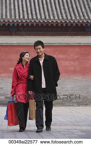 A couple walk together with shopping bags View Large Photo Image Stock Photo - A couple walk together with shopping bags. Fotosearch