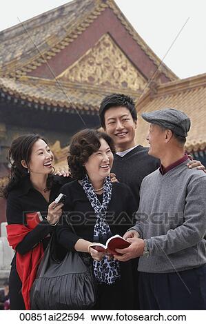Picture - A family laugh together in front of The Forbidden City, Beijing. Fotosearch