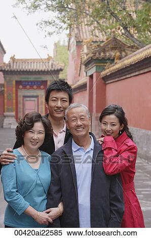 Stock Photography - A family look at the camera as they pose for photos together while on vacation. Fotosearch