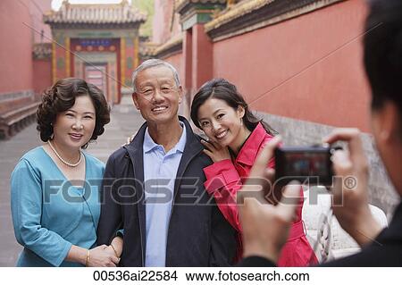 Picture - A family pose for photos together while on vacation. Fotosearch