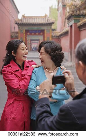 A family pose for photos together while on vacation View Large Photo Image Stock Image - A family pose for photos together while on vacation. Fotosearch