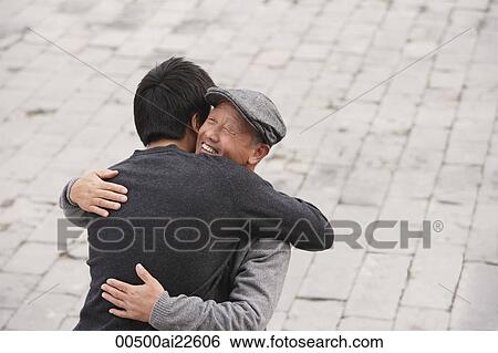 A grandfather and grandson hug each other View Large Photo Image Stock Photograph - A grandfather and grandson hug each other. Fotosearch