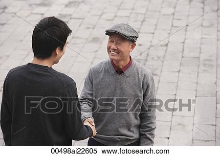 A grandfather and grandson shake hands View Large Photo Image Stock Photography - A grandfather and grandson shake hands. Fotosearch