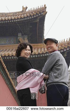 Stock Photo - A man and a woman look back at the camera in The Forbidden City, Beijing. Fotosearch