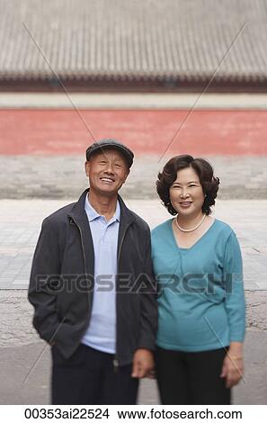 Picture - A man and a woman smile at the camera together. Fotosearch