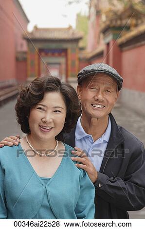 Stock Photo - A man and a woman smile at the camera together. Fotosearch